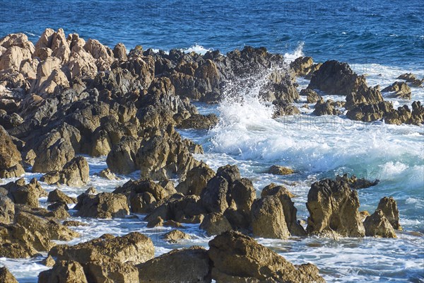 Wild sea meets a rocky coastline with splashing waves and spray, Methoni sea fortress, Peloponnese, Greece, Europe