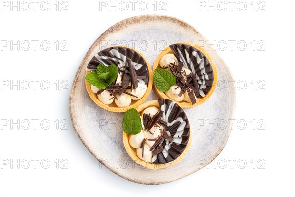 Sweet tartlets with chocolate and cheese cream isolated on white background. top view, flat lay, close up