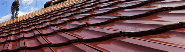 Panoramic image of the roof covering of a new tiled roof on a residential building