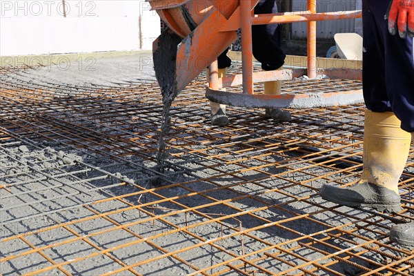 Concreting a floor slab with ready-mixed concrete on the construction site of a residential building