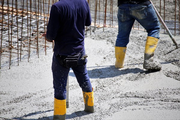 Concreting a floor slab with ready-mixed concrete on the construction site of a residential building