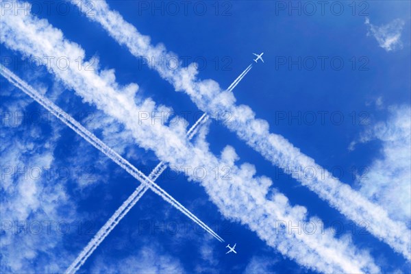 Vapor trails and passenger jets high in the sky