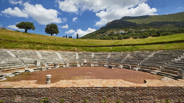 Ruins of an ancient theatre with seating steps standing out against the blue sky, Ancient theatre, Archaeological site, Ancient Messene, Capital of Messinia, Messini, Peloponnese, Greece, Europe