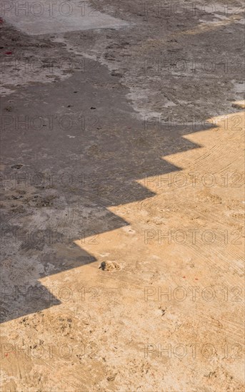 Shadow of steps cast on concrete pier on sunny day in South Korea