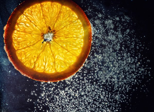 Transparent slices of fresh oranges and lemons on the glass with sugar