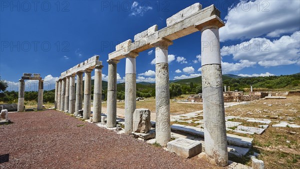 A row of ancient marble columns against a blue sky, Stoa of the Agora, Archaeological site, Ancient Messene, capital of Messinia, Messini, Peloponnese, Greece, Europe