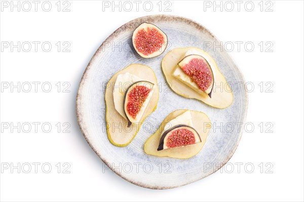 Summer appetizer with pear, cottage cheese, figs and honey on ceramic plate isolated on white background. Top view, flat lay, close up