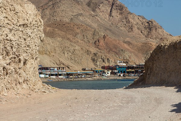 The coastline of the Red Sea with small resorts and the mountains in the background. Coral reef Blue Hole. Egypt, the Sinai Peninsula, Dahab