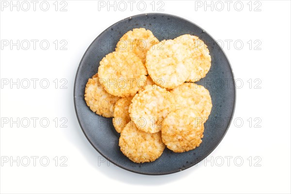 Traditional japanese rice chips cookies with honey and soy sauce on a blue ceramic plate isolated on white background. top view, close up, flat lay