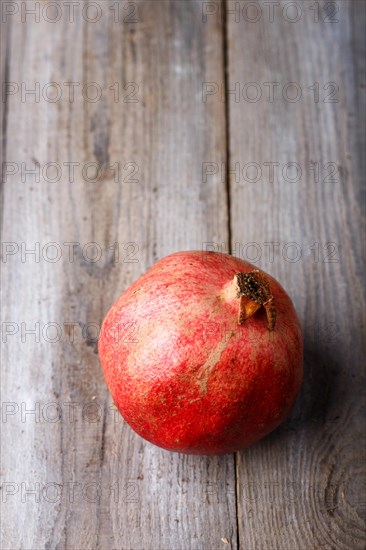 Ripe garnet on a rustic wooden background