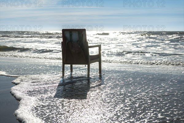 Upholstered chair washed up on the North Sea shore, flotsam, Oksbol, Region Syddanmark, Denmark, Europe