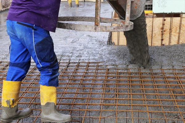 Concreting a floor slab with ready-mixed concrete on the construction site of a residential building