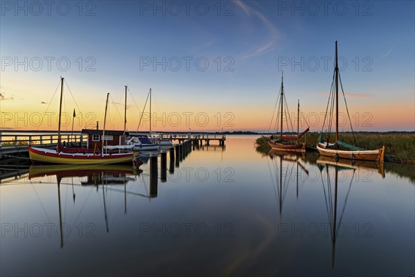 Old sailing boats in the harbour of Wieck on the Darss in the morning light