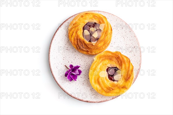 Small cheesecakes with jam and almonds isolated on white background. top view, flat lay, close up
