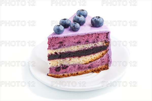 Homemade cake with souffle cream and blueberry jam isolated on white background. side view