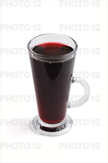 Glass of red grape juice isolated on white background. Morninig, spring, healthy drink concept. Side view, close up
