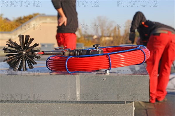 Workers from Abfluss AS clean the exhaust air ducts in an apartment block in Mannheim