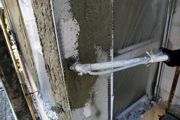 Plasterer plastering an exterior wall