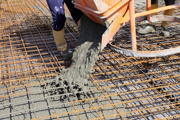 Concreting a floor slab with ready-mixed concrete on the construction site of a residential building