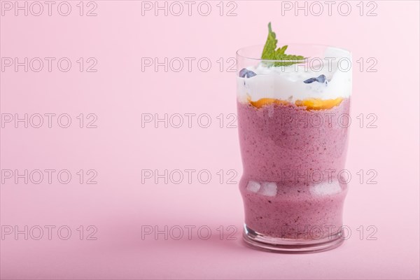 Smoothie with honeysuckle, linen and chia in a glass on pink pastel background. side view, close up, copy space