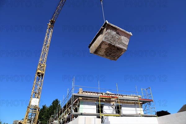 A container for the disposal of construction waste is placed on a construction site