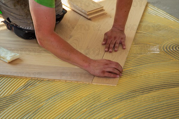 Craftsmen laying herringbone parquet professionally