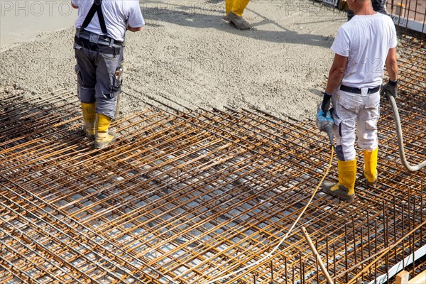 Delivery of ready-mixed concrete to the construction site of a residential building in a new development area in Mutterstadt, Palatinate