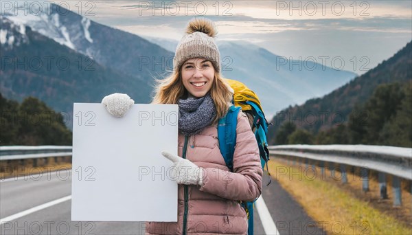 AI generated, human, humans, person, persons, woman, woman, one person, 20, 25, years, outdoor shot, seasons, cap, bobble hat, gloves, winter jacket, cold, cold, backpack, woman wants to travel, hitchhiking, hitchhiking, hitchhiking, road, motorway, holding a white sign, text free space