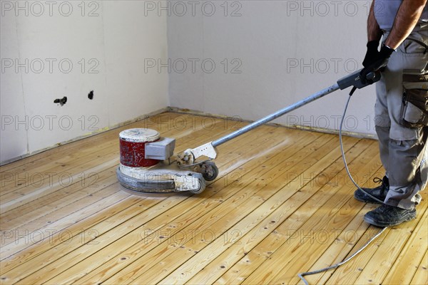 A parquet floor is sanded and oiled