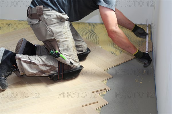 Craftsmen laying herringbone parquet professionally