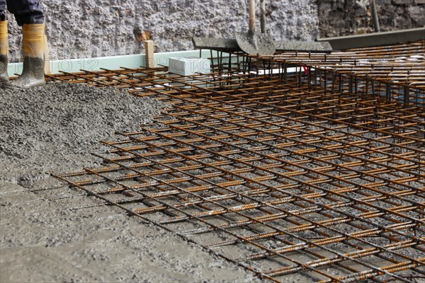 Concreting a floor slab with ready-mixed concrete on the construction site of a residential building