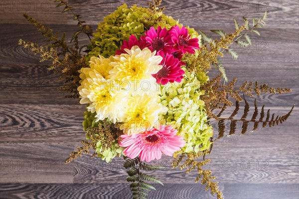 Bouquet of gerbera and chrysanthemum on a wooden background. floristic composition