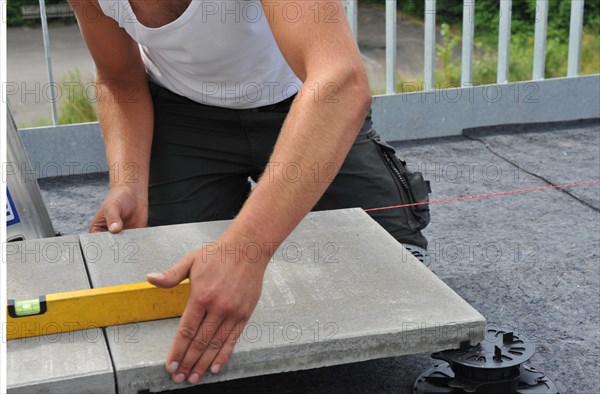 Worker lays paving stones