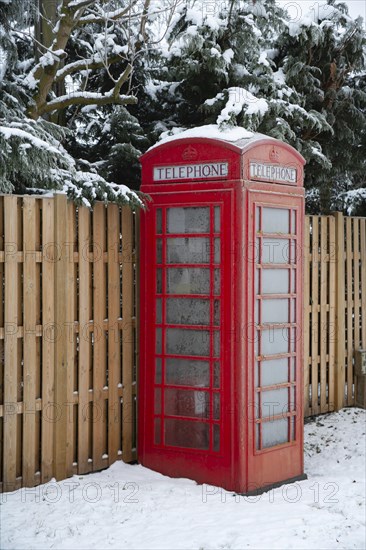 UK red telephone box covered in snow on a winter day, Suffolk, England, United Kingdom, Europe