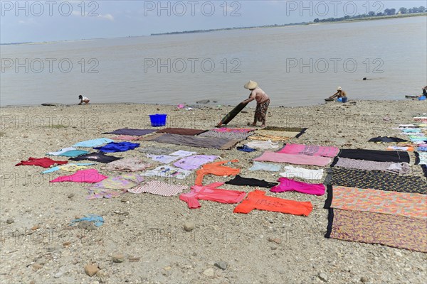 Washing clothes in the Irrawaddy, Myanmar, Asia