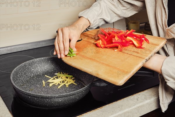 Unrecognizable woman preparing dressing for rice noodles