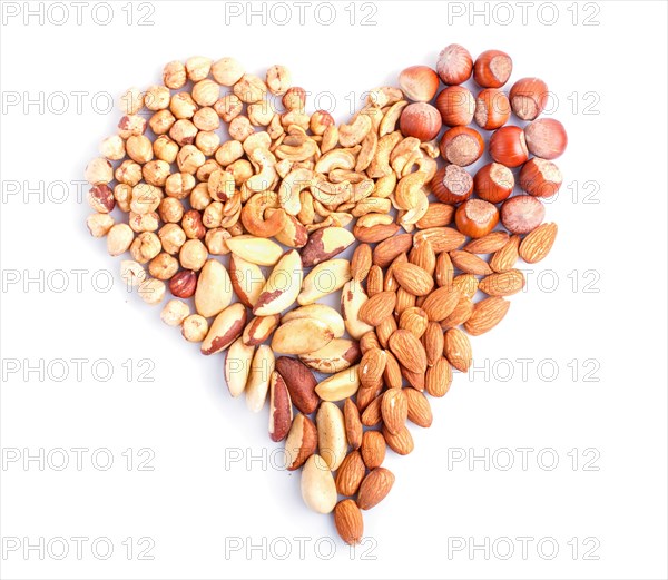 Heart made from different kinds of nuts isolated on white background. hazelnut, brazil nut, almond, pumpkin seeds, cashew. top view