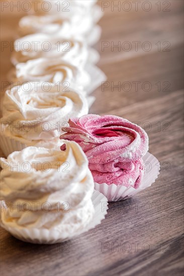 Pink and white homemade marshmallows on a gray wooden background. selective focus