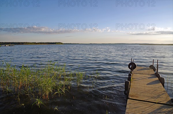 Small, deserted jetty on a lake in the evening light, Kristinehamm, Goeta Canal, Goetaland, Sweden, Europe