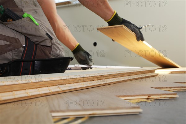 Craftsmen laying herringbone parquet professionally