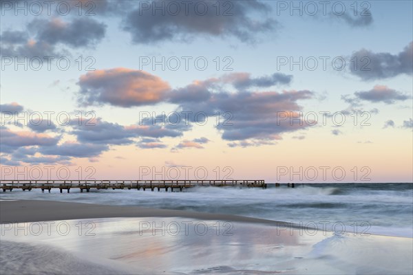 Sunrise at the pier of zingst during an icy storm as a long exposure