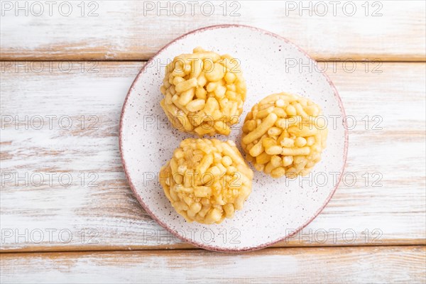 Traditional Tatar candy chak-chak made of dough and honey on a white wooden background. top view, flat lay, close up