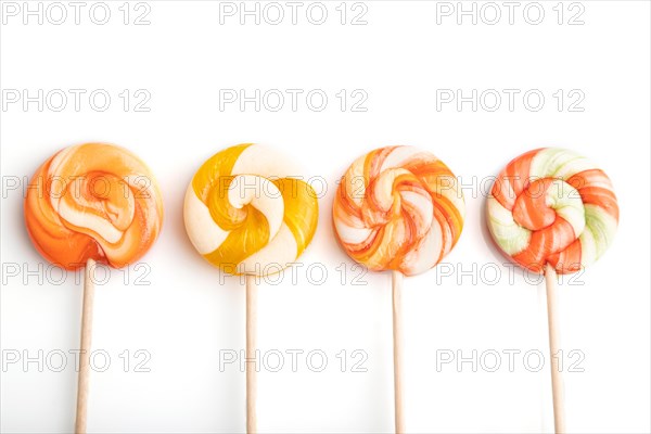 Four lollipop candies isolated on white background. close up, top view, flat lay