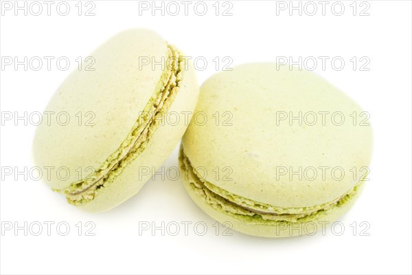 Green macarons or macaroons cakes isolated on white background. side view, close up, macro