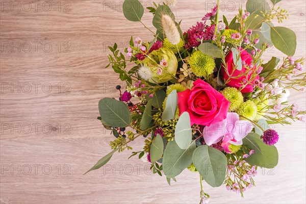 Composition of autumn flowers in a hat box on a wooden background. floristic arrangement. copy space