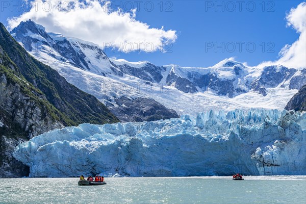 Passengers of the cruise ship Stella Australis in rubber dinghies in front of the ice of the Porter Glacier, Alberto de Agostini National Park, Avenue of the Glaciers, Chilean Arctic, Patagonia, Chile, South America
