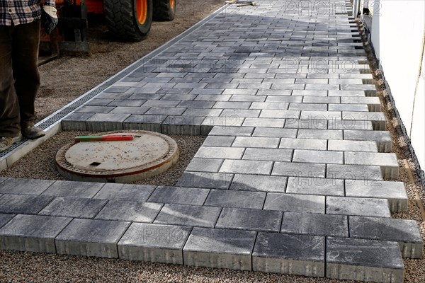 Worker lays paving stones