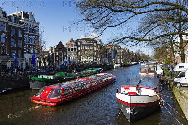 Canal cruise with typical tourist boat, tour, canal tour, city tour, tourism, city trip, holiday, travel, city exploration, city tour, centre, Amsterdam, Netherlands