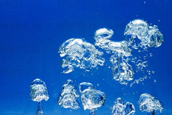 Bright Air bubbles, blue background in an aquarium