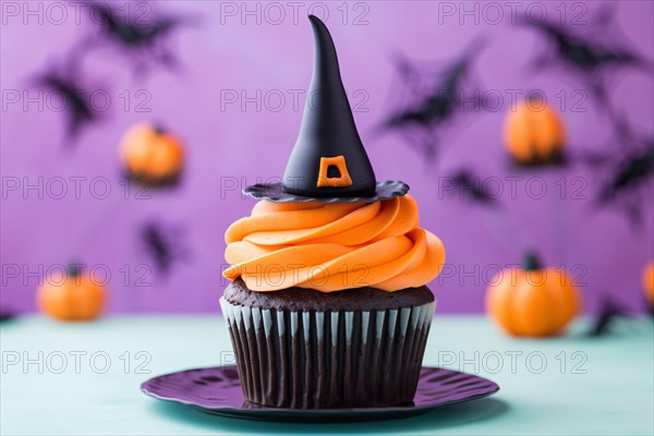 Halloween cupcake with orange frosting and black witch hat topping. KI generiert, generiert AI generated